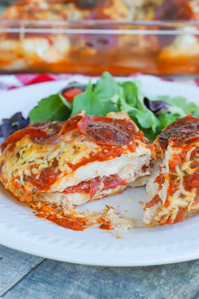 Pizza Stuffed Chicken cut in half on a plate