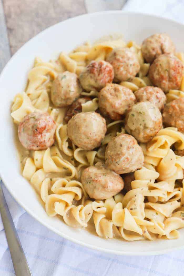 Slow Cooker Swedish Meatballs with noodles in white bowl