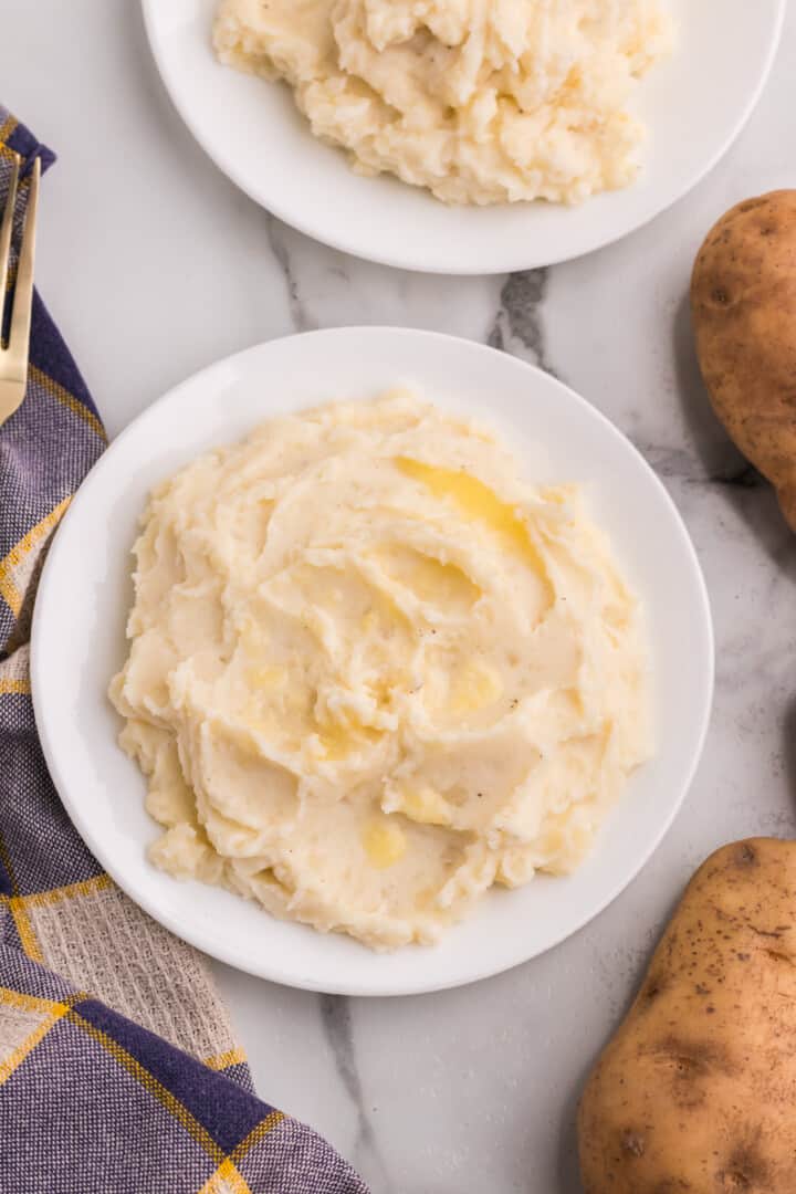 Mashed Potatoes served on a white plate.