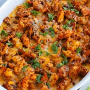 Chicken and Rice Queso Casserole in a white casserole dish
