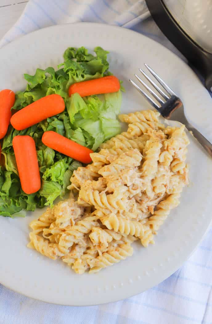 Slow Cooker Italian Chicken Pasta on a plate with salad and carrots