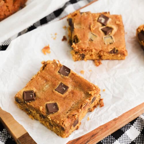 two Chocolate Chip Pumpkin Bars on a wooden board