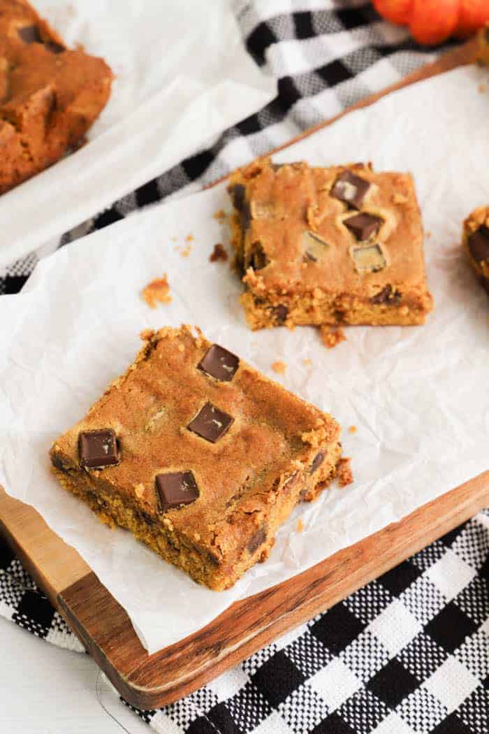 two Chocolate Chip Pumpkin Bars on a wooden board