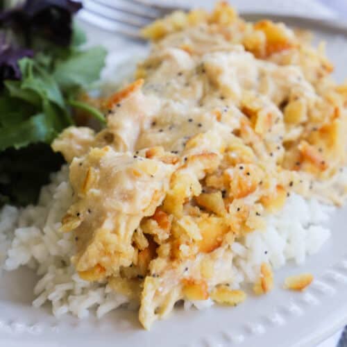 Slow Cooker Poppy Seed Chicken on a plate over rice