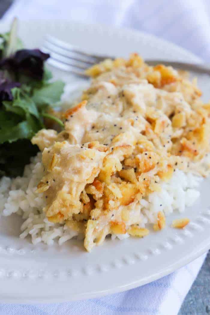 Slow Cooker Poppy Seed Chicken on a plate over rice