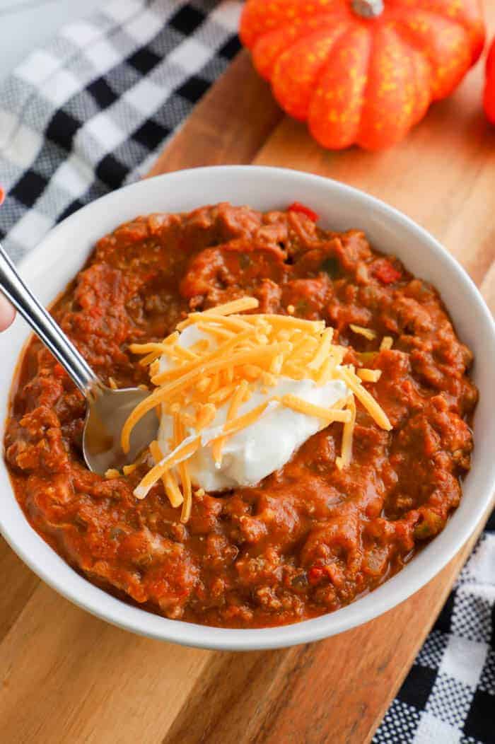 slow cooker pumpkin chili recipe in a bowl with spoon