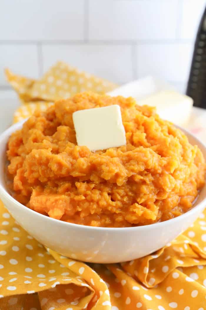 Mashed Sweet Potatoes in a white bowl with butter