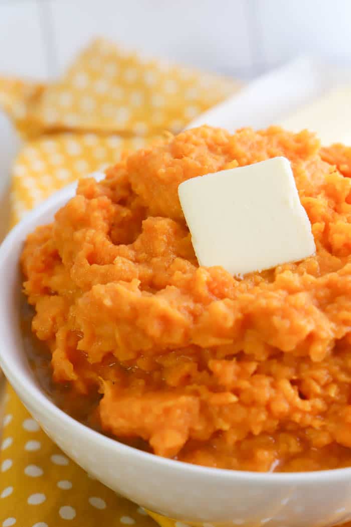 close up Mashed Sweet Potatoes with a slice of butter on top