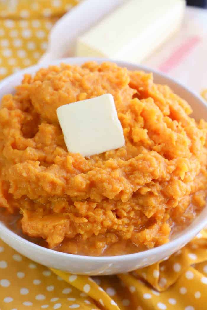 Mashed Sweet Potatoes in a bowl on a yellow polka dot napkin