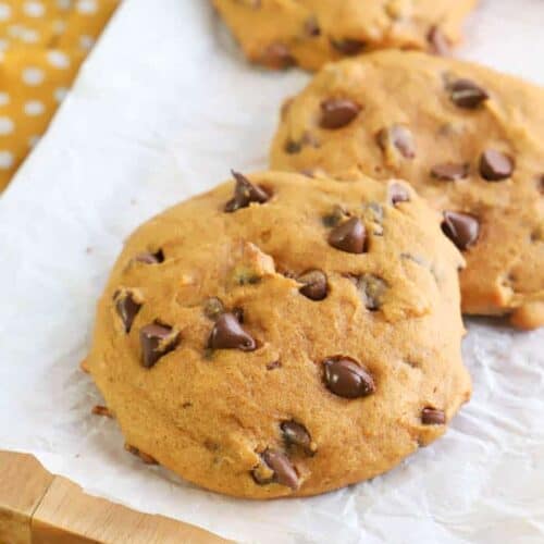 Pumpkin Chocolate Chip Cookies sitting on table with yellow napkin