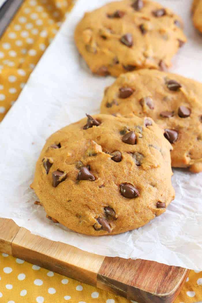 Pumpkin Chocolate Chip Cookies sitting on table with yellow napkin