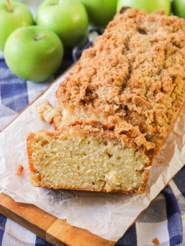 Dutch Apple Pie Bread Sliced on wooden board with apples