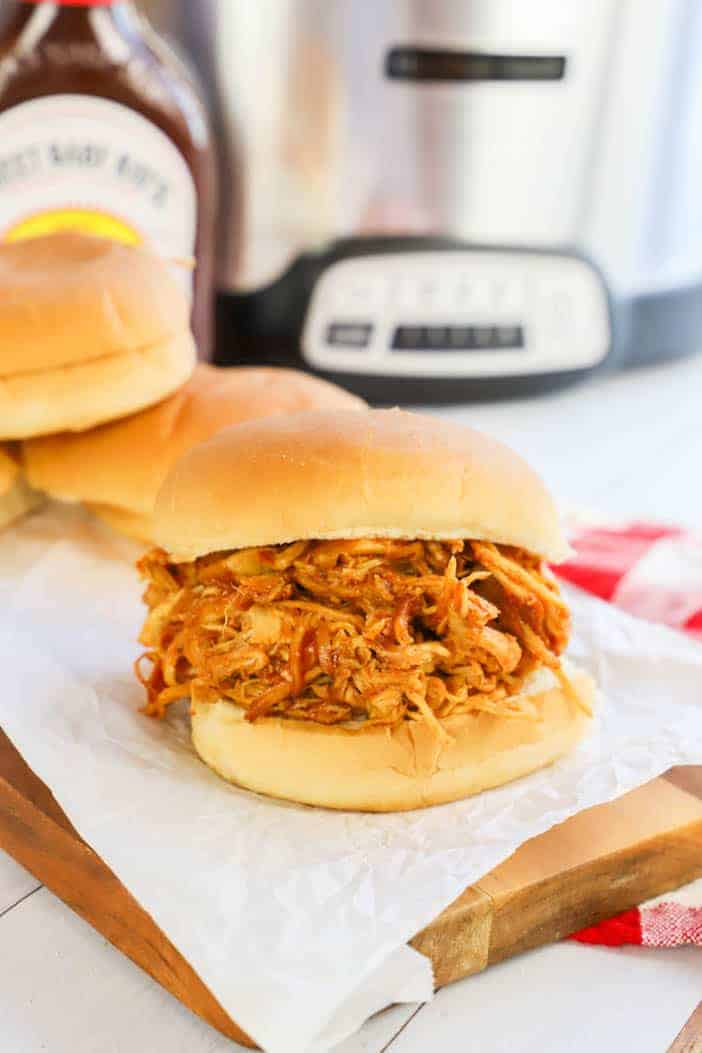 Slow Cooker Pulled BBQ Chicken on a wooden board