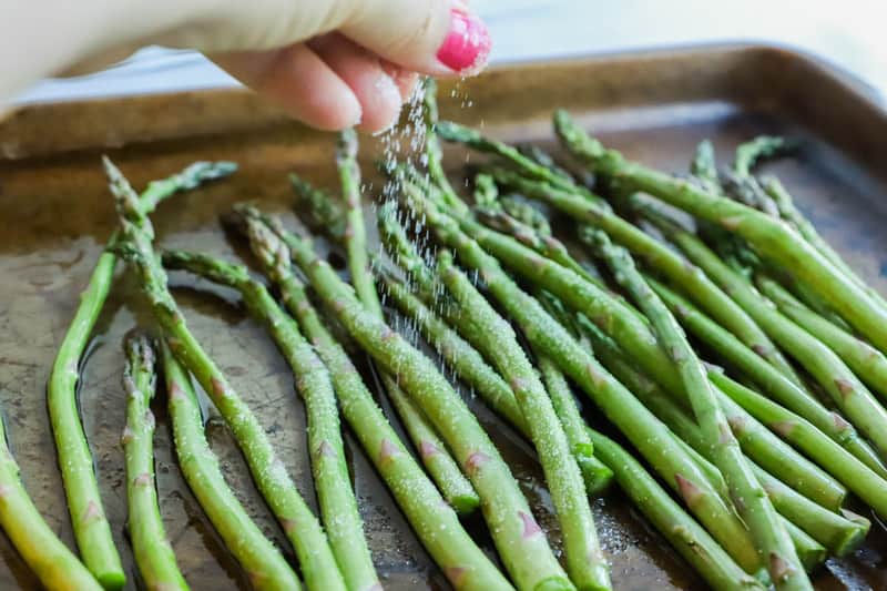 sprinkling Asparagus with salt