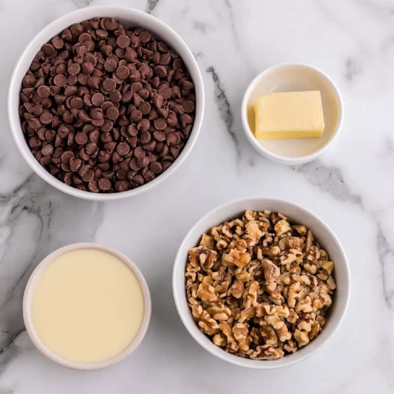 all ingredients for Chocolate Walnut Fudge in white bowls
