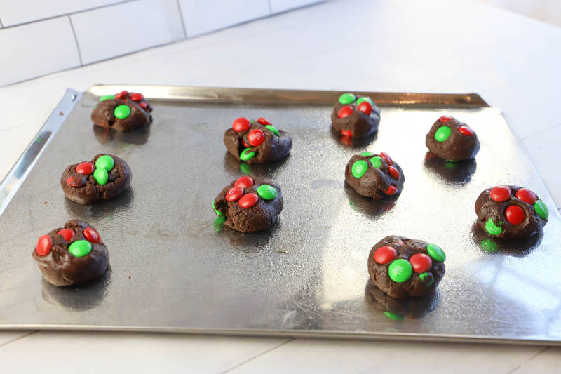 adding MM candies to the baking sheet