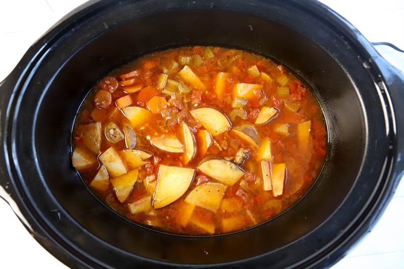 adding broth into the slow cooker