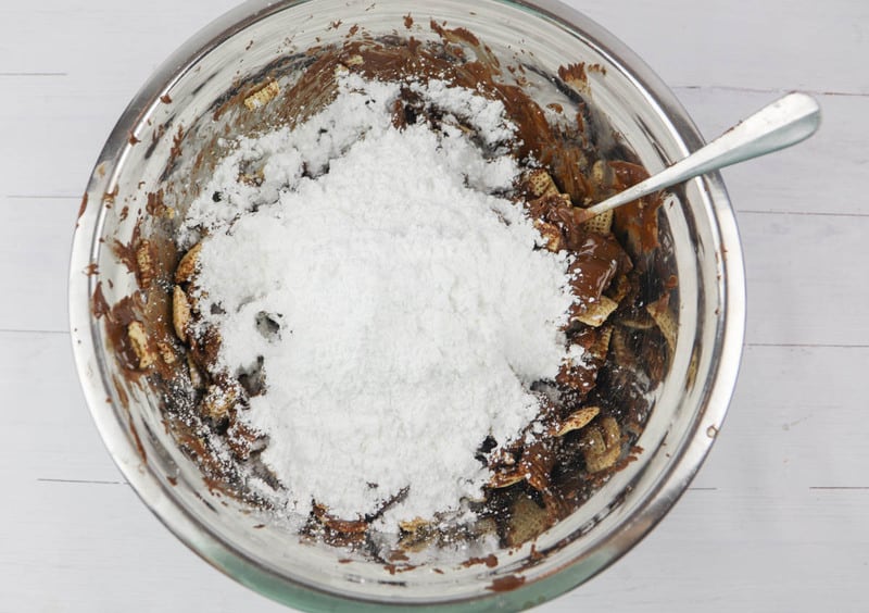 powdered sugar in the bowl with cereal in large mixing bowl