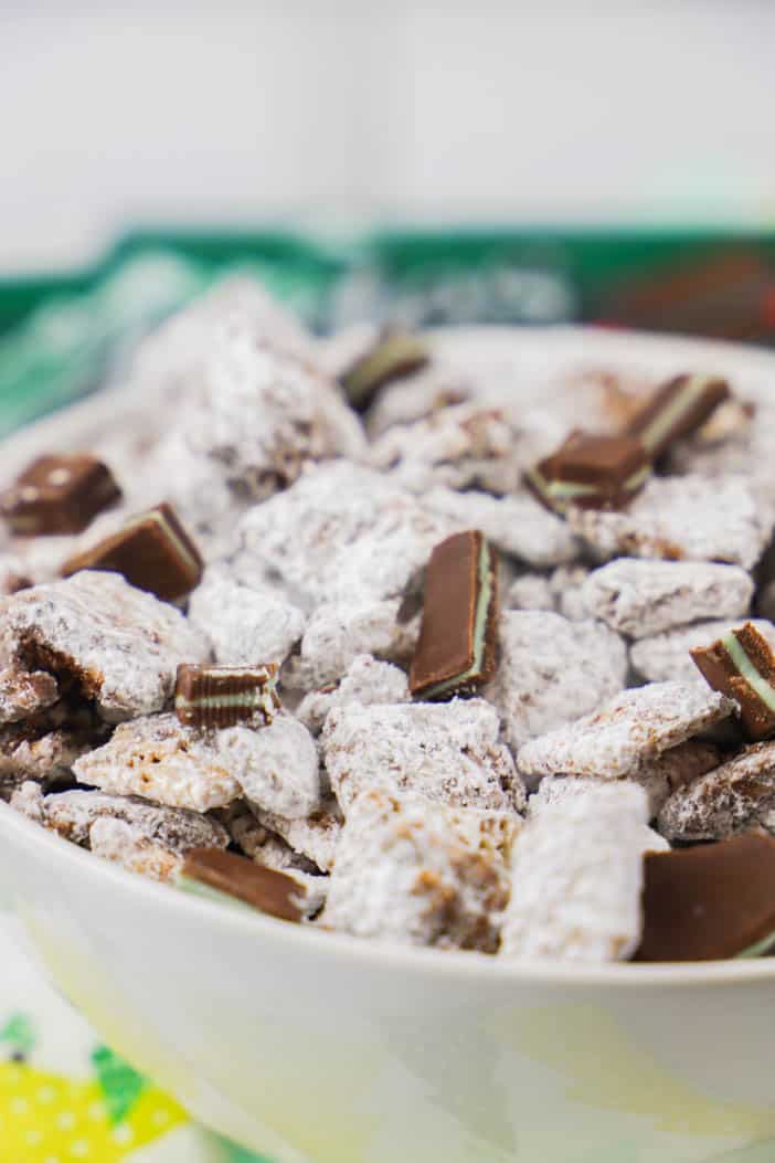 Place the unwrapped Andes in a microwave safe bowl. Melt in the microwave for 30 seconds at a time removing, stirring, and cooking, until fully melted. Add Chex cereal to a large mixing bowl. Pour in melted chocolate and gently mix until cereal is coated. Next (and quickly before your chocolate dries) add in powder sugar and again gently mix until all cereal is coated. Add broken up Andes chocolate mints pieces and serve.