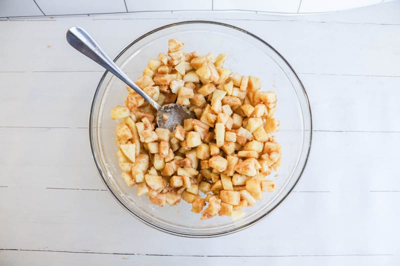 apple pie filling mixed in clear bowl