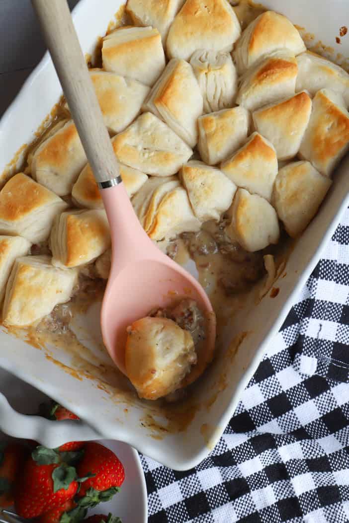serving casserole with a pink spoon