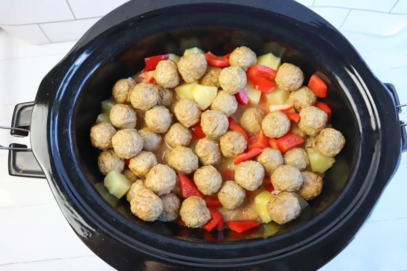 pouring sauce over meatballs