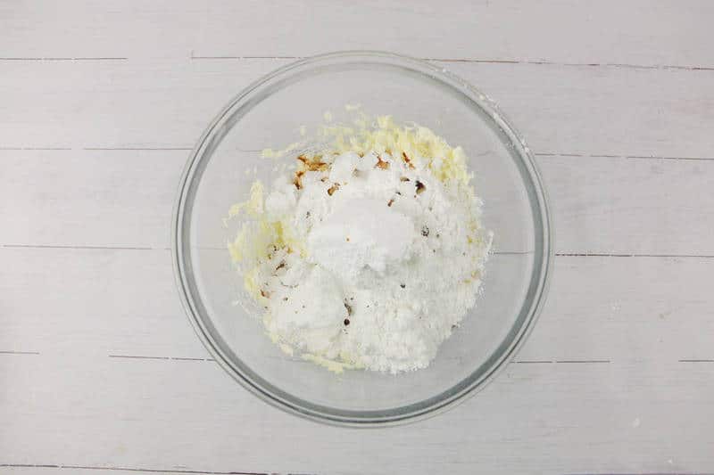 mixing frosting ingredients in a glass bowl.