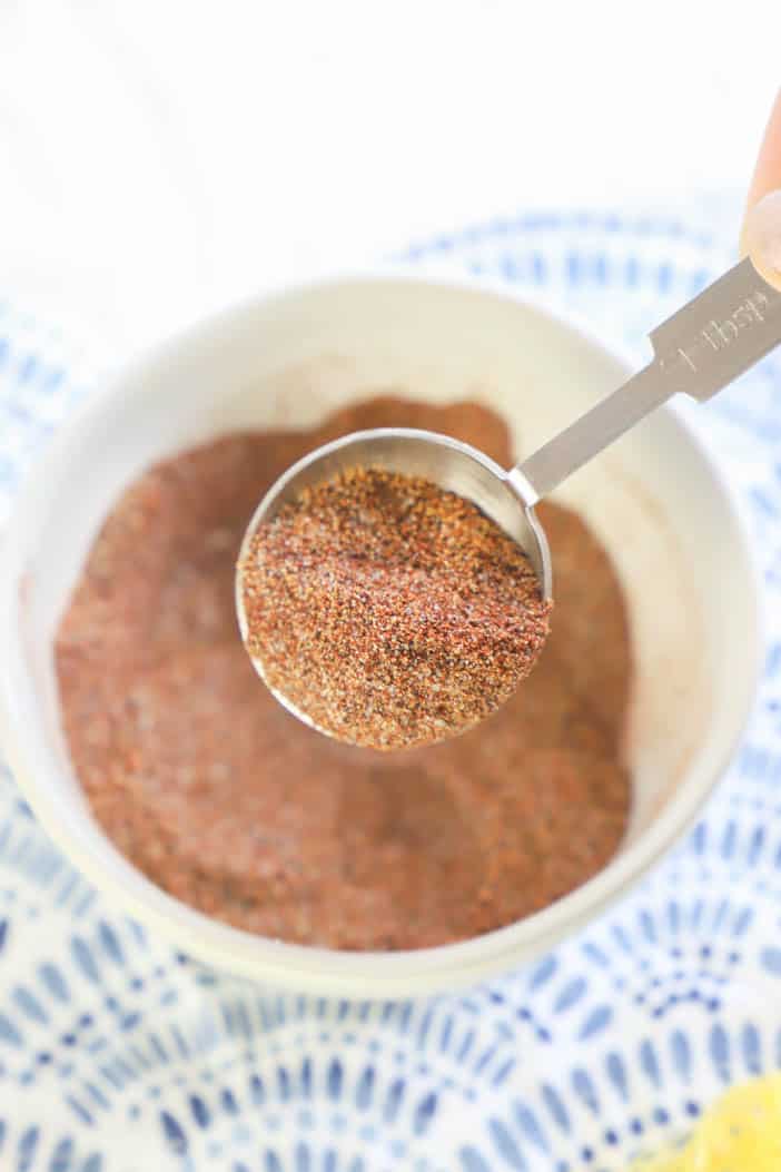 Easy Homemade Taco Seasoning in a bowl with closeup on a measuring scoop
