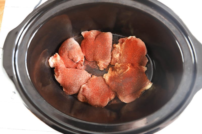 adding seasoning to the slow cooker