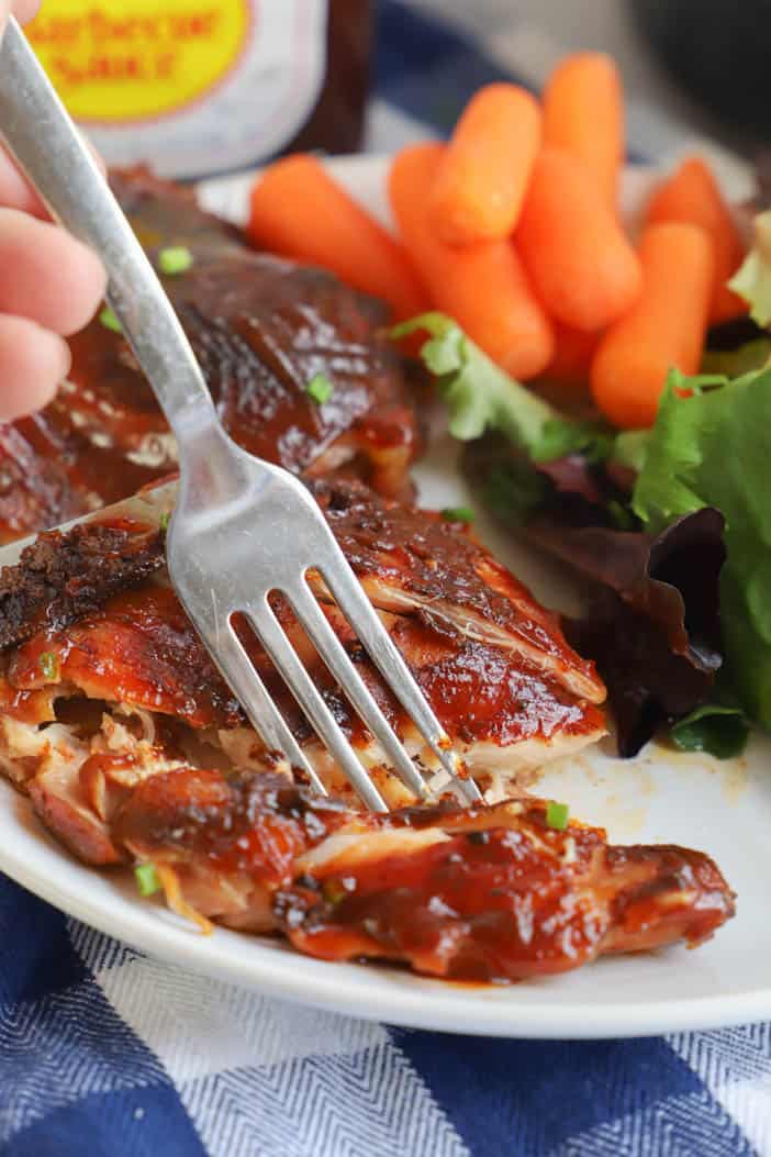 using a fork to eat Slow Cooker BBQ Chicken Thighs