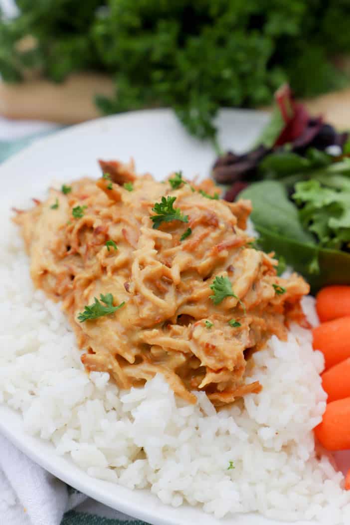 chicken served on a plate with rice and salad