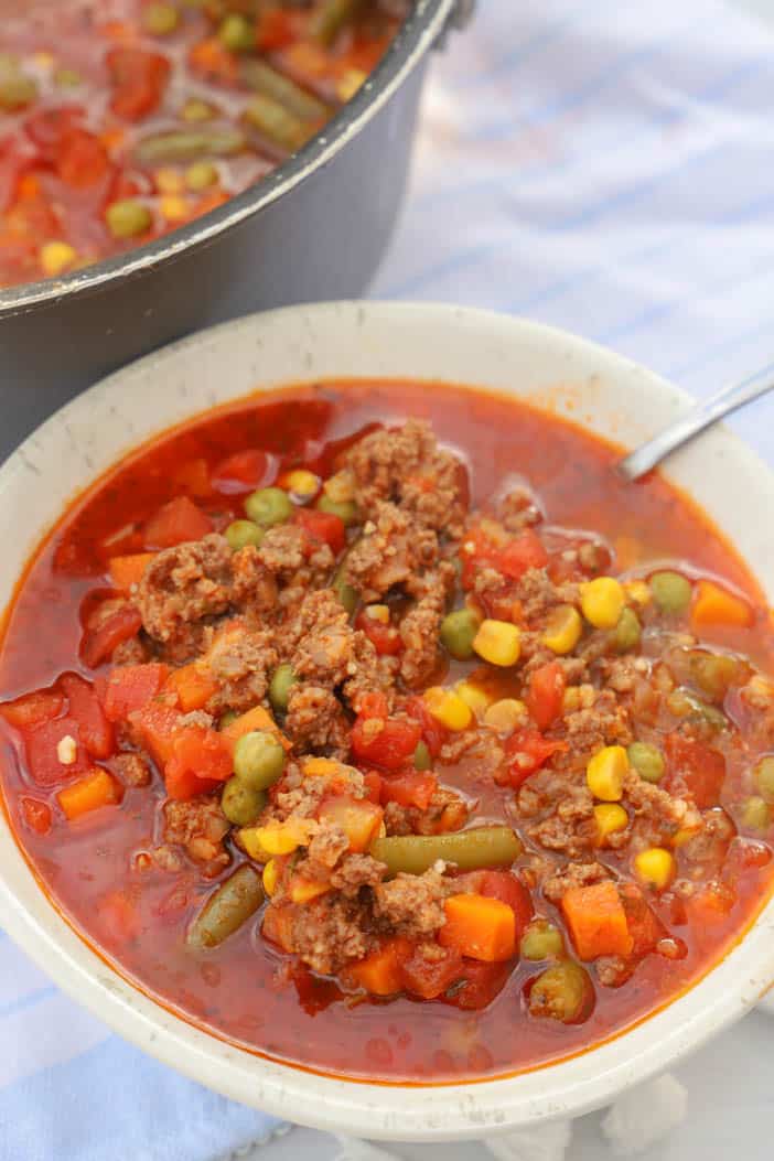 soup in a white bowl with silver spoon