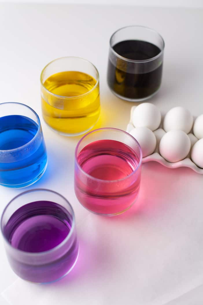 dipping cups with the dye for the eggs.