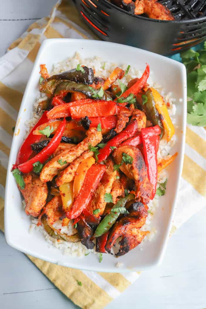 Air Fryer Chicken Fajitas in a white bowl on rice