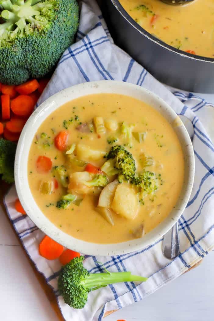 top view picture of soup in bowl with veggies around