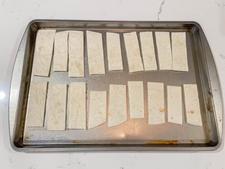 tortillas cut in strips on baking sheet