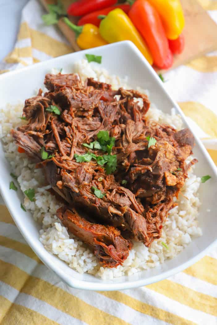 Slow Cooker Shredded Beef Tacos on a bed of rice