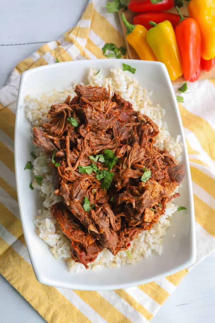 Slow Cooker Shredded Beef Tacos in a white bowl topped with cilantro