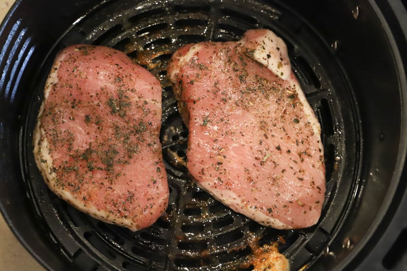 pork chops seasoned and in the air fryer.