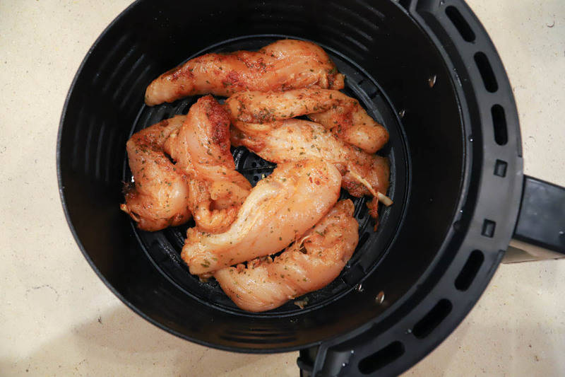 adding tenders to the air fryer before cooking