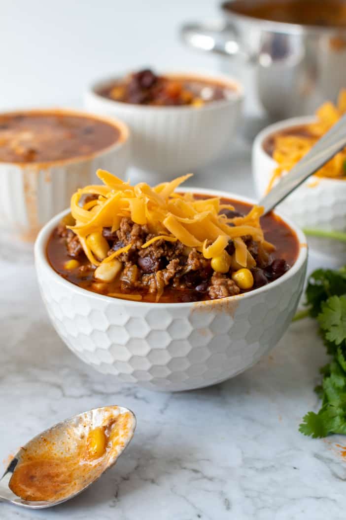 Taco Soup topped with shredded cheese.