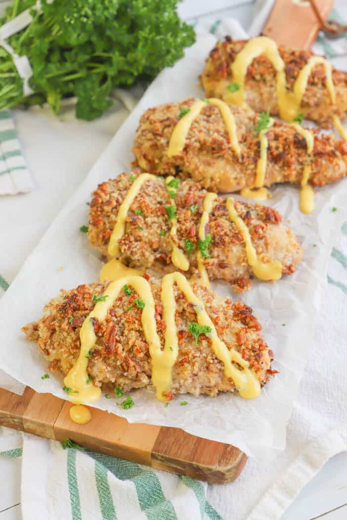 Honey Mustard Pecan Chicken laying on a wooden board