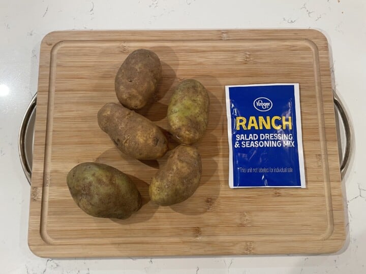 ingredients for roasted ranch potatoes on cutting board