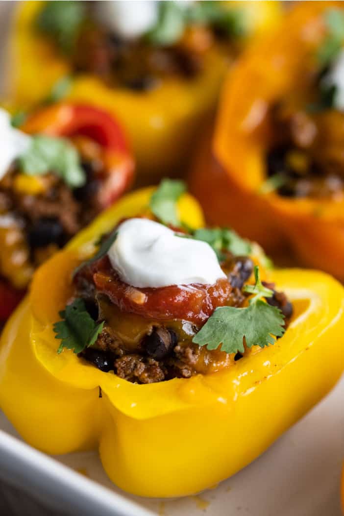 adding salsa and sour cream to the Mexican Stuffed Peppers