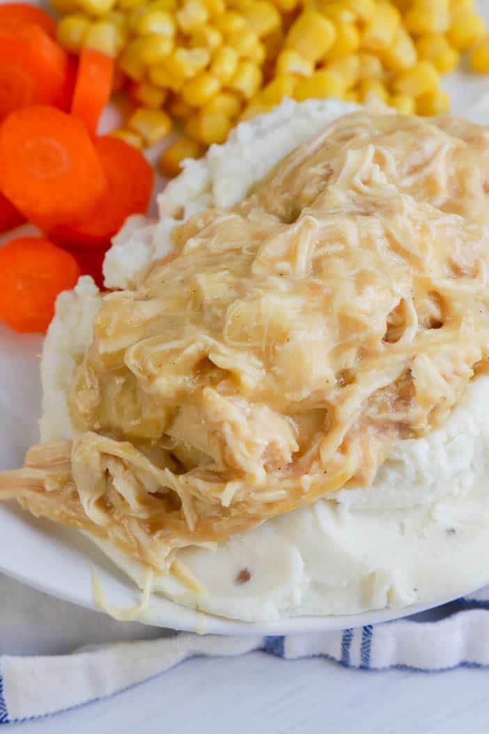 Slow Cooker Chicken and Gravy served with carrots and corn