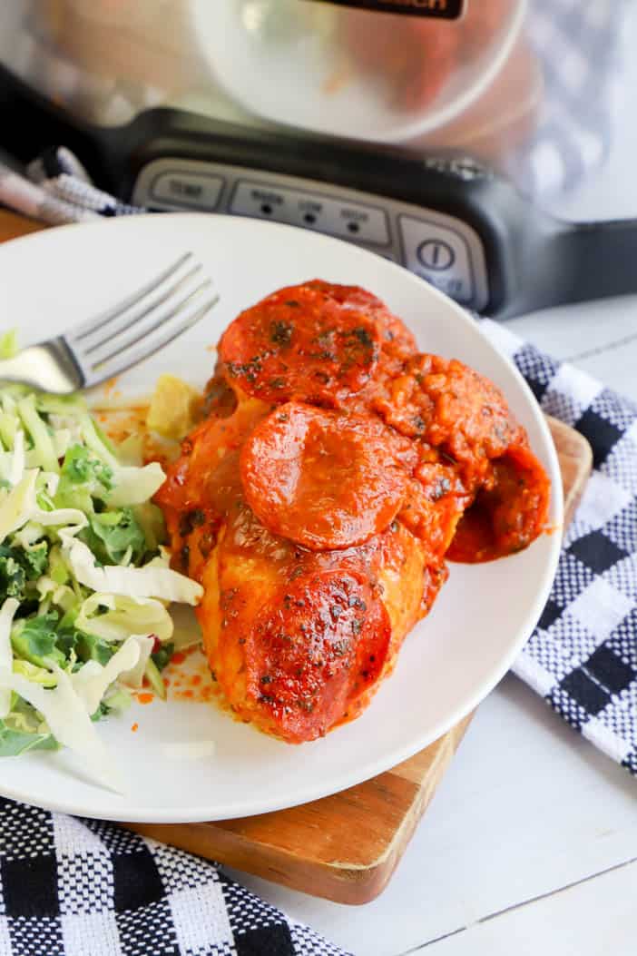 Slow Cooker Pizza Chicken in a plate with salad