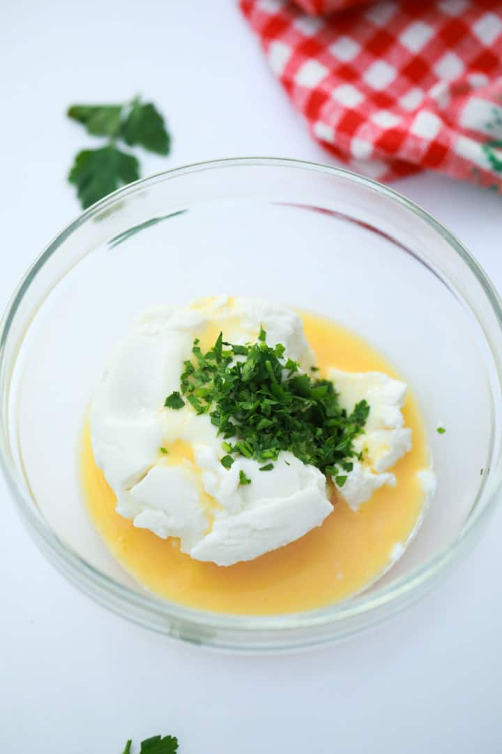cheese in a bowl with egg and parsley
