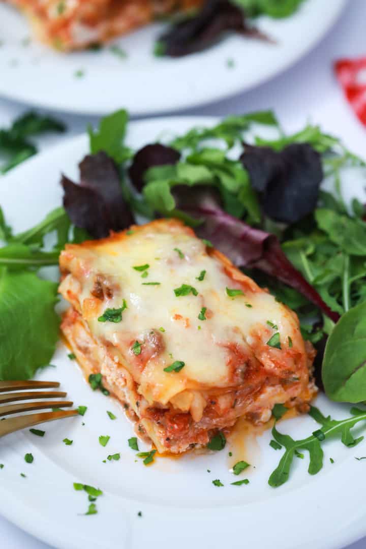 Lasagna on a plate with salad
