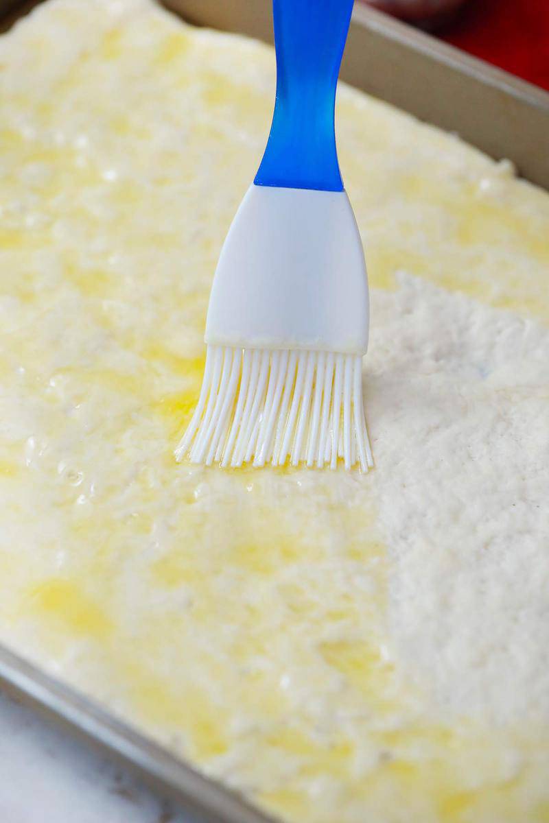 brushing the butter mix on to the dough
