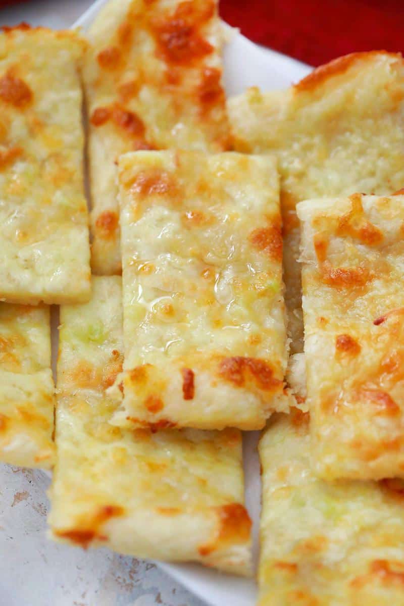 close up of garlic breadsticks sliced and stacked